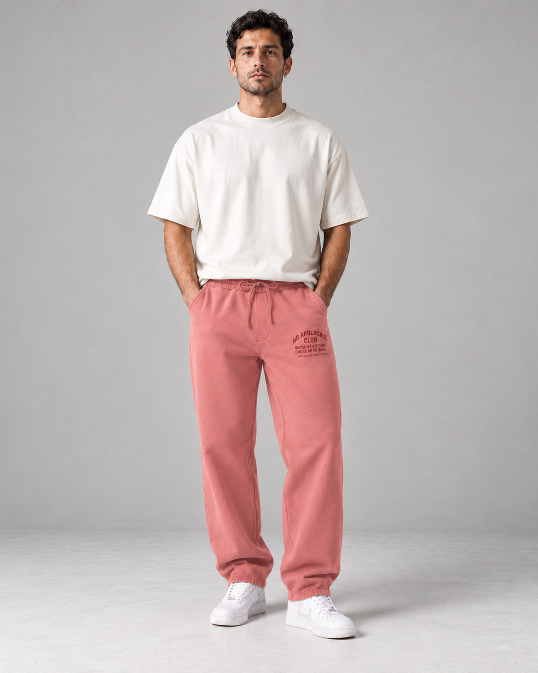 No Apologies pigment-dyed sweatpants in pink, worn by a man