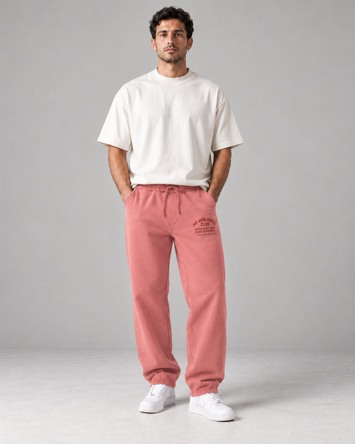 No Apologies pigment-dyed sweatpants in pink, worn by a man
